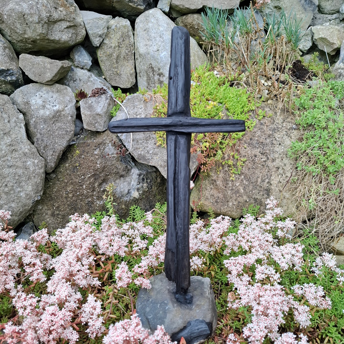 Handcrafted bog oak cross sculpture on fossil stone base, made in Galway, Ireland