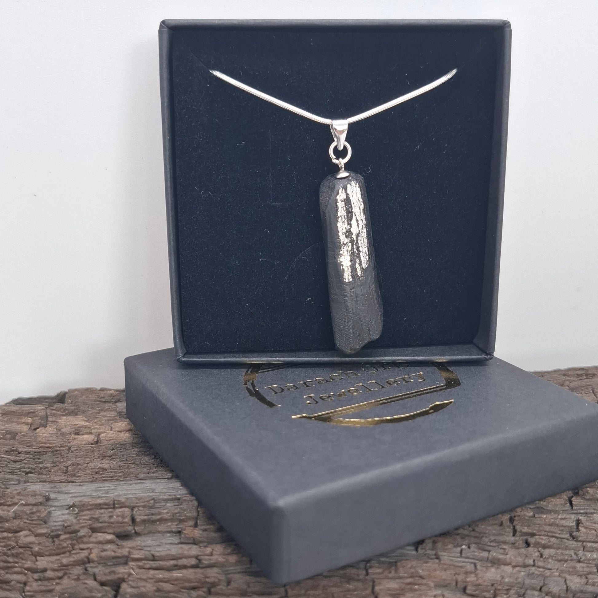Pendant made out of irish bog oak finished with gold or silver leaf and necklace