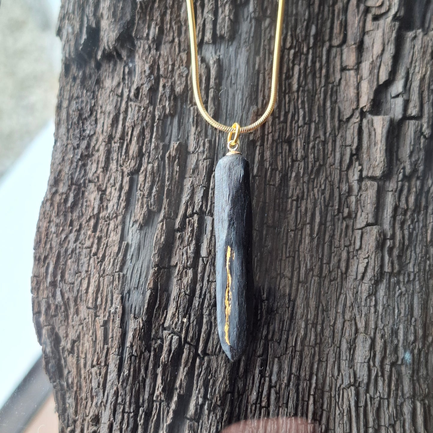 Pendant made out of irish bog oak finished with gold or silver leaf and necklace