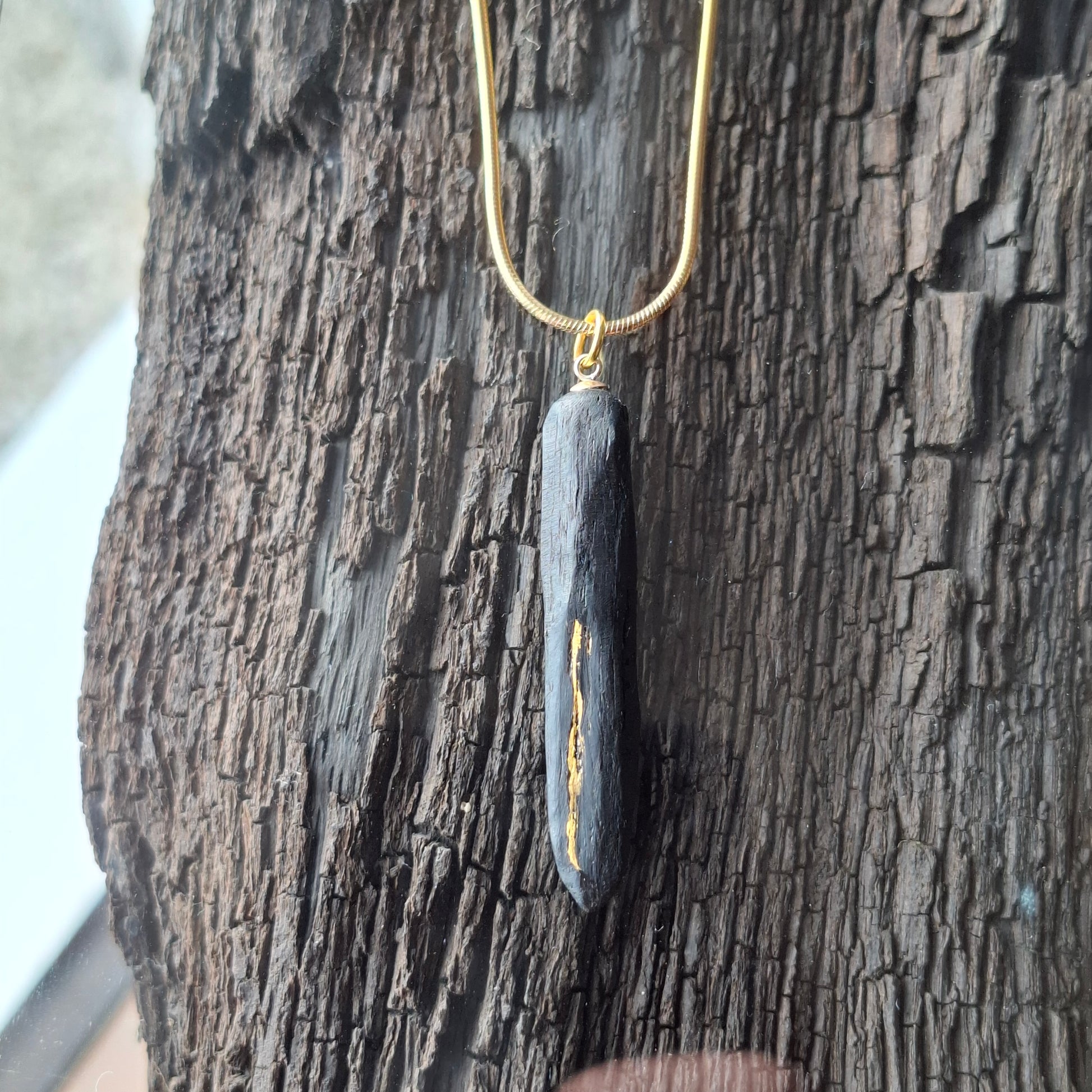 Pendant made out of irish bog oak finished with gold or silver leaf and necklace