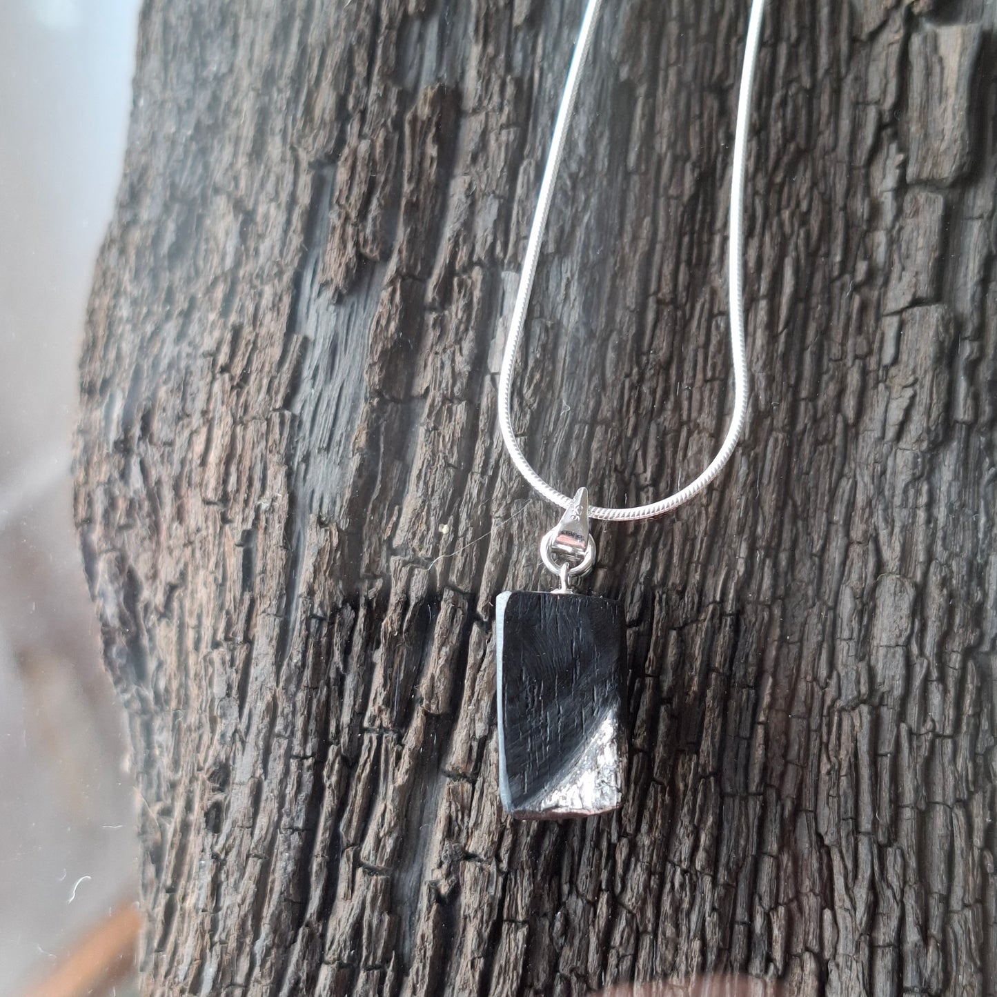Fionnuala - Irish bog oak with fine silver leaf and sterling silver chain